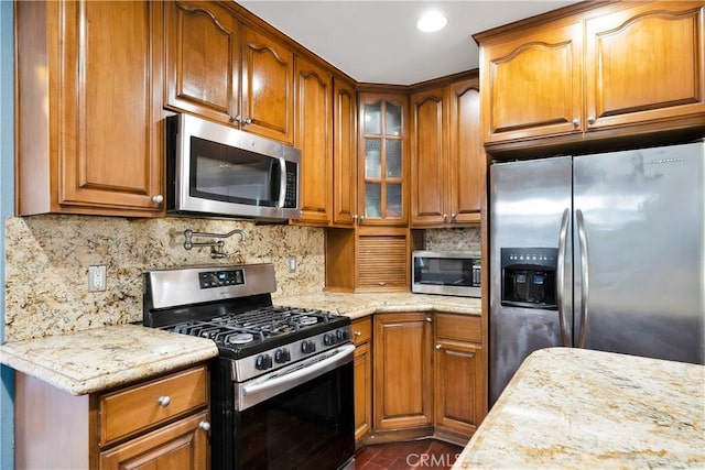 1914 S W View St, Los Angeles, CA 90016 - kitchen featuring appliances with stainless steel finishes, brown cabinets, glass insert cabinets, and recessed lighting