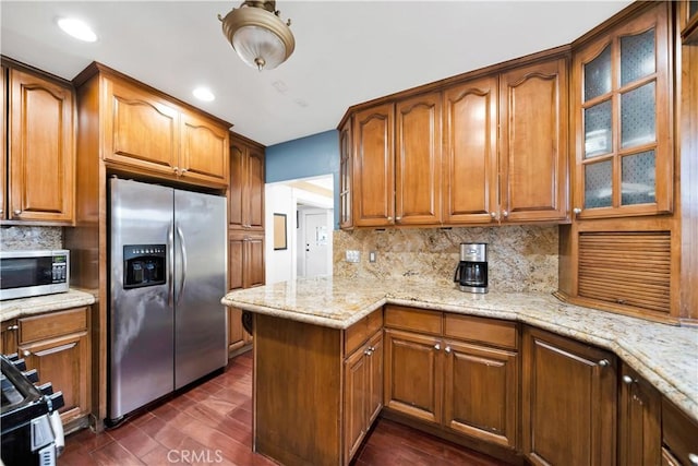 1914 S W View St, Los Angeles, CA 90016 - kitchen with appliances with stainless steel finishes, tasteful backsplash, brown cabinets, glass insert cabinets, and recessed lighting