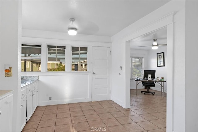 1914 S W View St, Los Angeles, CA 90016 - kitchen featuring a desk, white cabinetry, light tile patterned floors, a ceiling fan, and light countertops