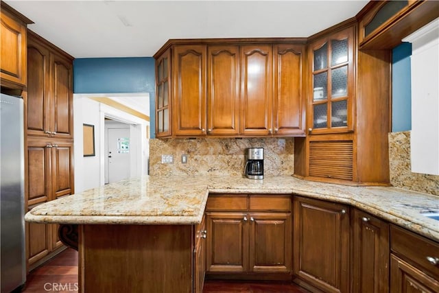 1914 S W View St, Los Angeles, CA 90016 - kitchen featuring freestanding refrigerator, decorative backsplash, light stone countertops, and glass insert cabinets