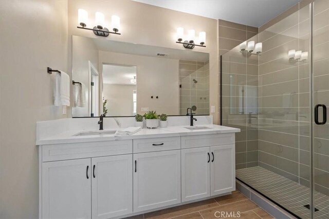 176 Tango Way, San Luis Obispo, CA 93401 - bathroom with a shower stall, double vanity, and wood finished floors