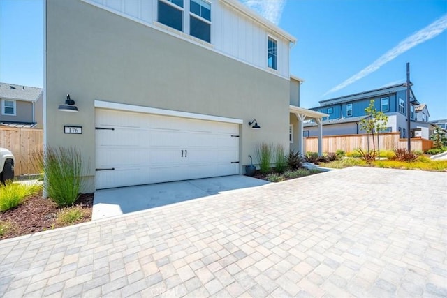176 Tango Way, San Luis Obispo, CA 93401 - view of front of house with decorative driveway, a garage, and board and batten siding