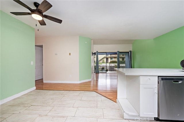 3505 Angelucci St Unit 2E, San Diego, CA 92111 - kitchen featuring stainless steel dishwasher, light countertops, baseboards, and white cabinetry