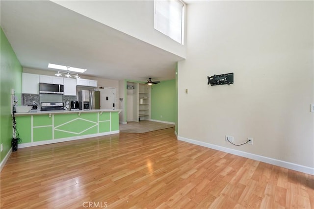 3505 Angelucci St Unit 2E, San Diego, CA 92111 - unfurnished living room with baseboards, light wood-style floors, and a ceiling fan