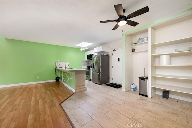 3505 Angelucci St Unit 2E, San Diego, CA 92111 - kitchen featuring stainless steel appliances, a sink, a peninsula, light wood-type flooring, and a ceiling fan