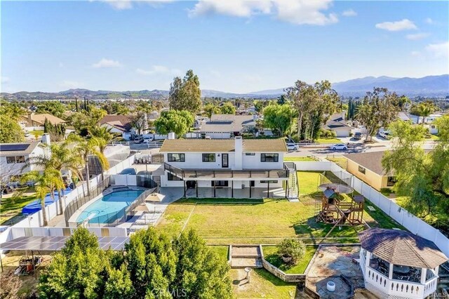 2416 Hialeah Cir, Norco, CA 92860 - aerial view of residential area with a mountainous background and a pool area