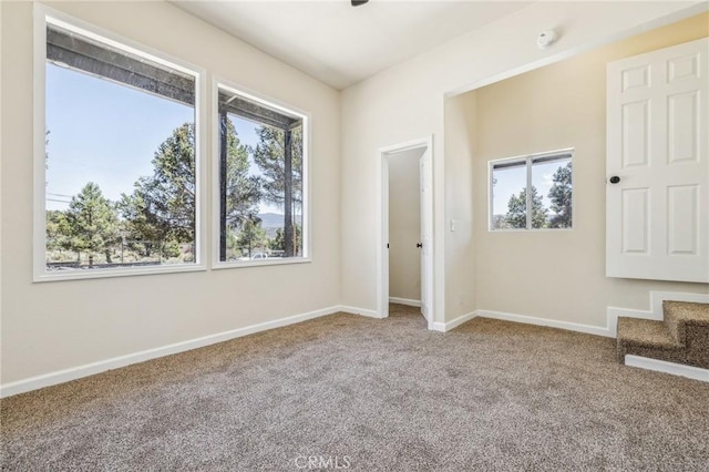 1850 Pond, Big Bear City, CA 92314 - unfurnished room with healthy amount of natural light, carpet flooring, baseboards, and stairs