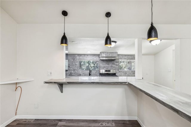 1850 Pond, Big Bear City, CA 92314 - kitchen featuring stainless steel range oven, wood finished floors, tasteful backsplash, and hanging light fixtures