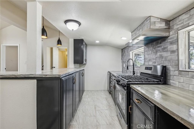 1850 Pond, Big Bear City, CA 92314 - kitchen with stainless steel gas range, wall chimney exhaust hood, light marble finish floors, backsplash, and dark cabinetry