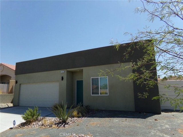 12612 Maui Way, Desert Hot Springs, CA 92240 - view of front facade with stucco siding, a garage, and driveway
