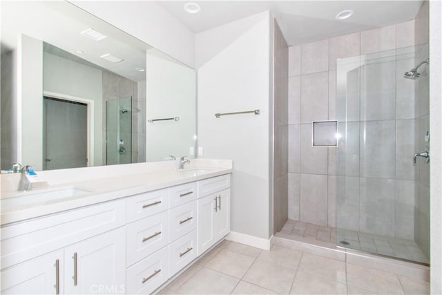 12612 Maui Way, Desert Hot Springs, CA 92240 - bathroom with double vanity, a shower stall, tile patterned floors, and baseboards