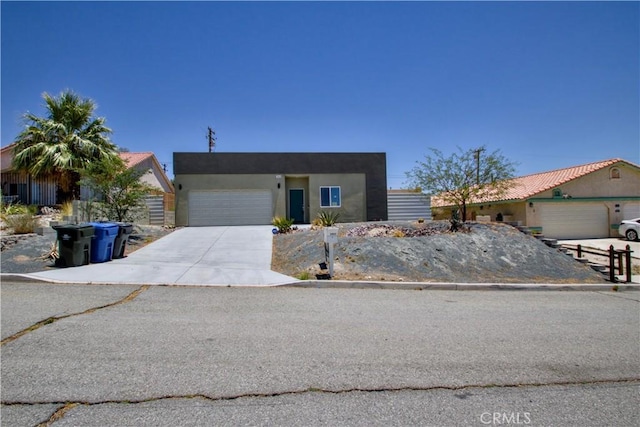 12612 Maui Way, Desert Hot Springs, CA 92240 - view of front of home featuring an attached garage, driveway, and stucco siding