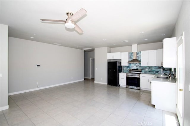 12612 Maui Way, Desert Hot Springs, CA 92240 - kitchen with stainless steel range with electric cooktop, freestanding refrigerator, wall chimney exhaust hood, a sink, and backsplash