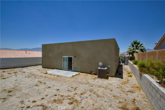 12612 Maui Way, Desert Hot Springs, CA 92240 - back of property with central AC, stucco siding, and a patio
