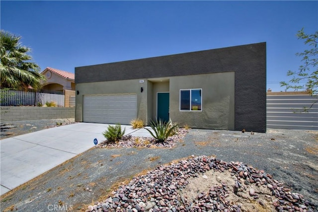 12612 Maui Way, Desert Hot Springs, CA 92240 - view of front of house with stucco siding, driveway, and a garage
