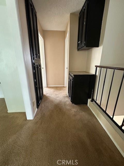 546 Northpoint Cir, Santa Maria, CA 93455 - hall with light carpet, a textured ceiling, and baseboards