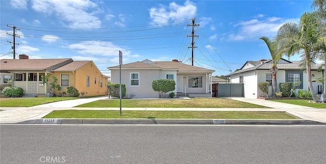 11206 Quinn St, Downey, CA 90241 - view of front facade featuring a front lawn, concrete driveway, and stucco siding
