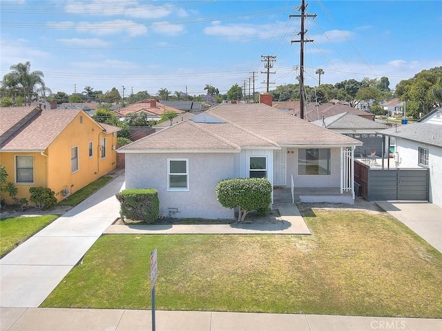 11206 Quinn St, Downey, CA 90241 - view of front facade featuring a front lawn, stucco siding, roof with shingles, and a residential view