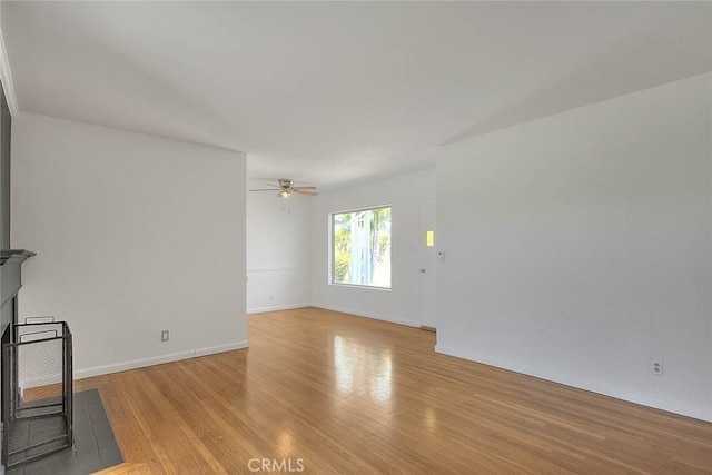 11206 Quinn St, Downey, CA 90241 - unfurnished living room with light wood-style flooring, ceiling fan, and baseboards