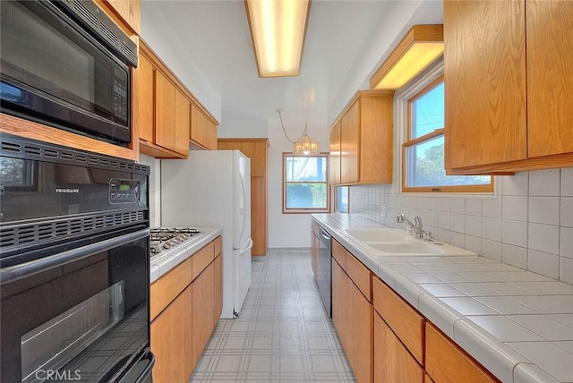 11206 Quinn St, Downey, CA 90241 - kitchen featuring black appliances, a sink, backsplash, tile countertops, and light flooring