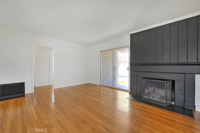 11206 Quinn St, Downey, CA 90241 - unfurnished living room with light wood-style floors, a fireplace, and baseboards