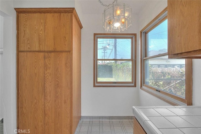 11206 Quinn St, Downey, CA 90241 - unfurnished dining area featuring a chandelier and baseboards
