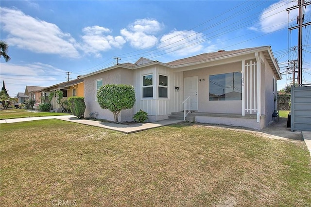 11206 Quinn St, Downey, CA 90241 - view of front facade featuring a front yard, board and batten siding, and entry steps