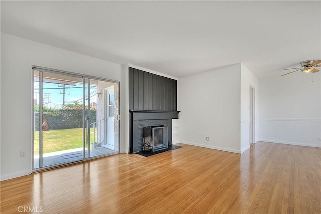 11206 Quinn St, Downey, CA 90241 - unfurnished living room with light wood-style flooring, a fireplace, baseboards, and a ceiling fan
