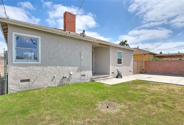 11206 Quinn St, Downey, CA 90241 - back of property featuring a patio area, a chimney, stucco siding, and crawl space