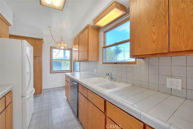 11206 Quinn St, Downey, CA 90241 - kitchen featuring freestanding refrigerator, stainless steel dishwasher, a sink, tasteful backsplash, and light floors