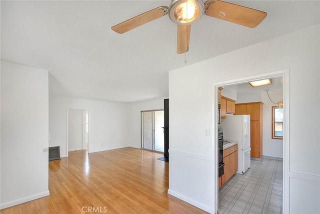 11206 Quinn St, Downey, CA 90241 - unfurnished living room featuring plenty of natural light, ceiling fan, light wood-style flooring, and baseboards