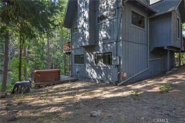 644 Grass Valley Rd, Lake Arrowhead, CA 92352 - view of property exterior with a hot tub and roof with shingles