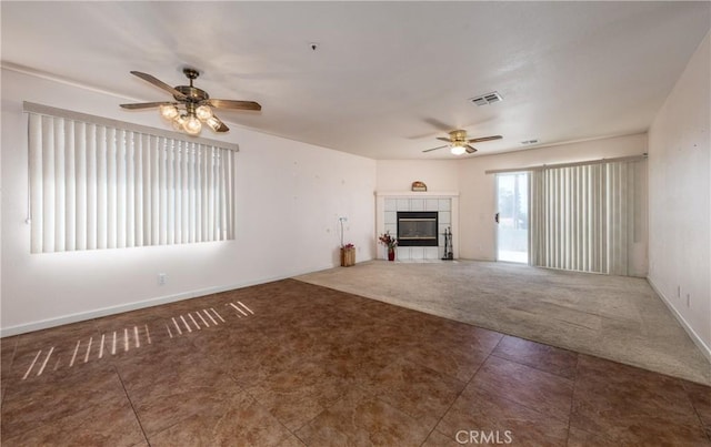 66427 3rd St, Desert Hot Springs, CA 92240 - unfurnished living room with a ceiling fan, carpet flooring, a tile fireplace, and baseboards