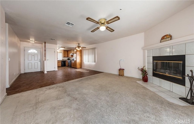 66427 3rd St, Desert Hot Springs, CA 92240 - unfurnished living room featuring dark carpet, ceiling fan, a tile fireplace, and baseboards