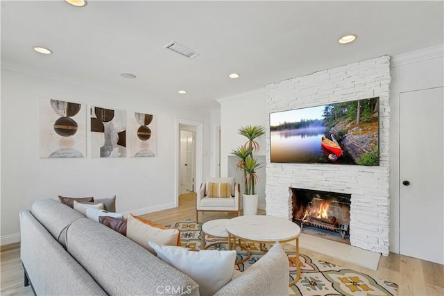 4901 Ethel Ave, Sherman Oaks, CA 91423 - living area with a stone fireplace, light wood-type flooring, recessed lighting, crown molding, and baseboards