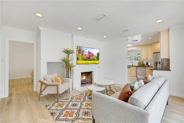 4901 Ethel Ave, Sherman Oaks, CA 91423 - living area with ornamental molding, baseboards, a large fireplace, light wood-type flooring, and recessed lighting