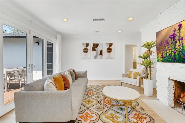 4901 Ethel Ave, Sherman Oaks, CA 91423 - living area with light wood-style floors, recessed lighting, a fireplace with flush hearth, crown molding, and french doors