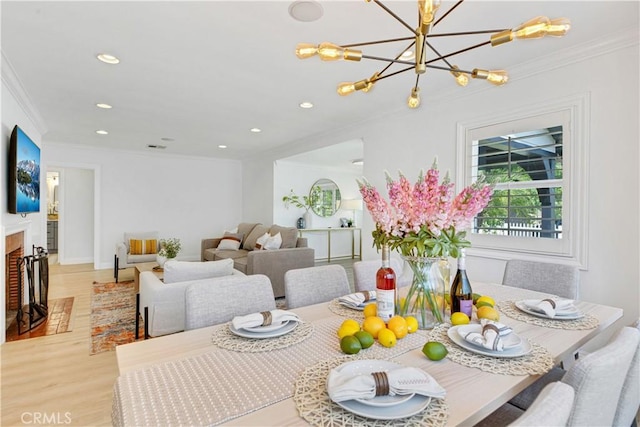 4901 Ethel Ave, Sherman Oaks, CA 91423 - dining space with light wood finished floors, crown molding, a chandelier, recessed lighting, and a fireplace with flush hearth