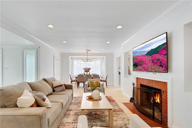 4901 Ethel Ave, Sherman Oaks, CA 91423 - living room with ornamental molding, light wood finished floors, a chandelier, recessed lighting, and a fireplace