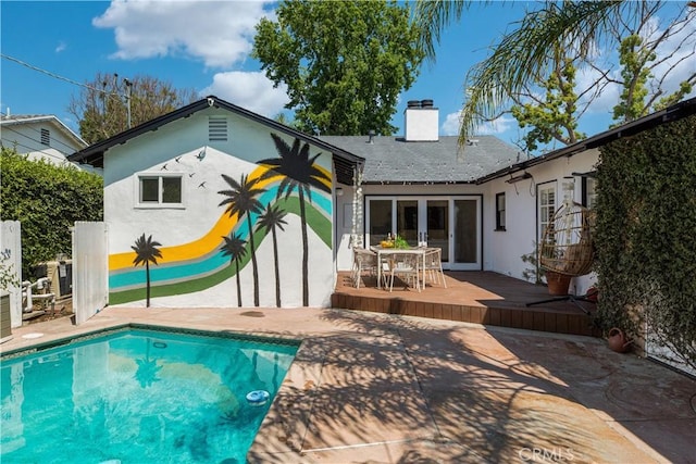 4901 Ethel Ave, Sherman Oaks, CA 91423 - rear view of property featuring a chimney, stucco siding, a deck, and outdoor dining area