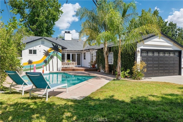 4901 Ethel Ave, Sherman Oaks, CA 91423 - back of house featuring a yard, concrete driveway, a chimney, stucco siding, and an attached garage