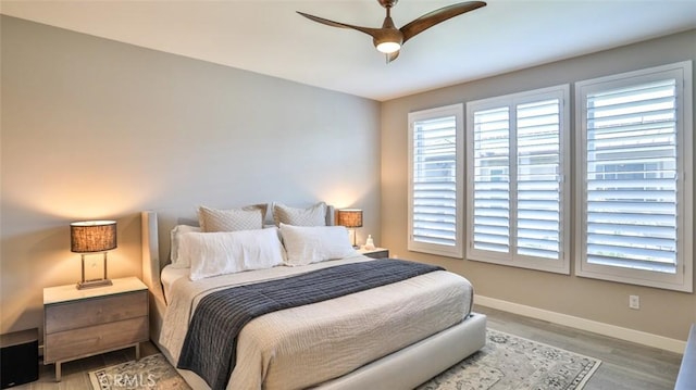 876 Doheny Way, Dana Point, CA 92629 - bedroom with baseboards, light wood-style flooring, and a ceiling fan