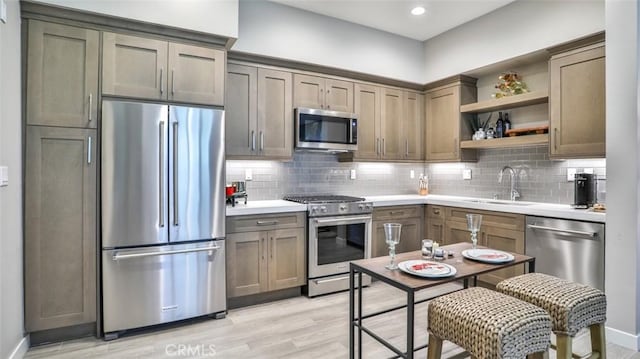 876 Doheny Way, Dana Point, CA 92629 - kitchen featuring appliances with stainless steel finishes, a sink, open shelves, decorative backsplash, and recessed lighting