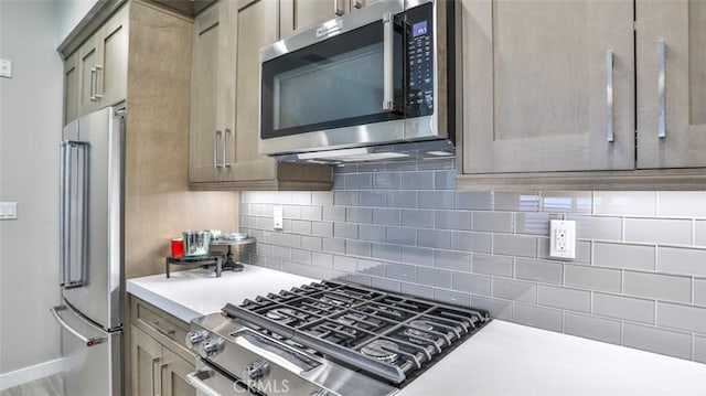 876 Doheny Way, Dana Point, CA 92629 - kitchen with appliances with stainless steel finishes, light countertops, decorative backsplash, and baseboards