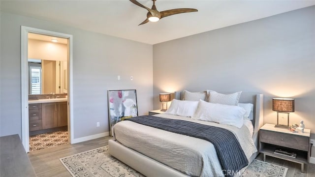 876 Doheny Way, Dana Point, CA 92629 - bedroom featuring a sink, wood finished floors, ensuite bathroom, and baseboards
