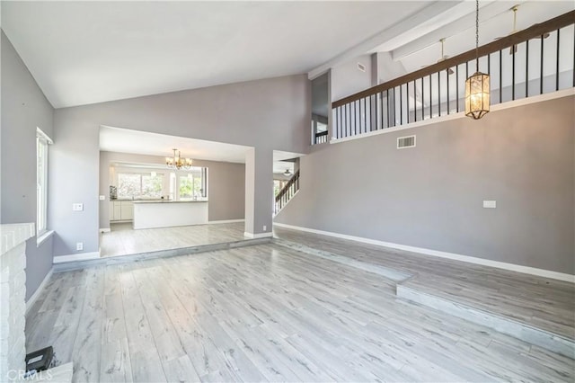 6114 Sard St, Rancho Cucamonga, CA 91701 - unfurnished living room featuring a chandelier, high vaulted ceiling, wood finished floors, and baseboards