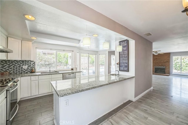 6114 Sard St, Rancho Cucamonga, CA 91701 - kitchen featuring light wood finished floors, a ceiling fan, light stone counters, white cabinetry, and stainless steel appliances