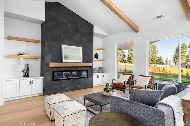4956 Malibu Dr, Paradise, CA 95969 - living room with light wood finished floors, plenty of natural light, a fireplace, recessed lighting, and high vaulted ceiling