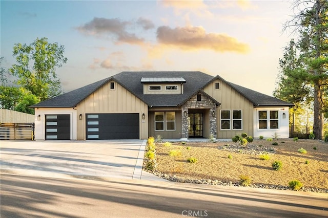 4956 Malibu Dr, Paradise, CA 95969 - view of front of house with a garage, concrete driveway, a shingled roof, stone siding, and board and batten siding