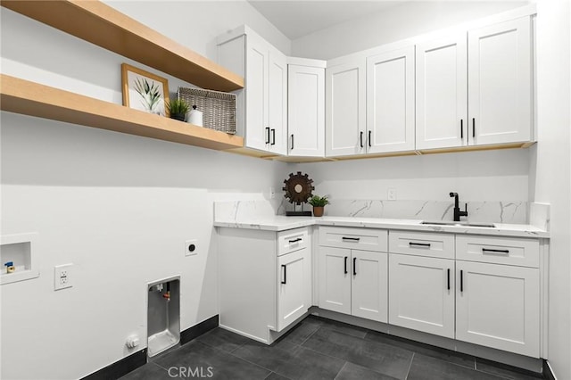 4956 Malibu Dr, Paradise, CA 95969 - washroom with hookup for a washing machine, electric dryer hookup, cabinet space, dark tile patterned flooring, and baseboards